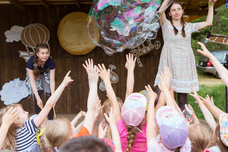 Grodno, Belarus - June 04, 2017: Group of kids have fun with big soap bubbles in a parkのeditorial素材