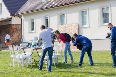 RADZIVILKI, BELARUS - OCT 10: Photographers shoot decorated for wedding elegant dinner table at the...