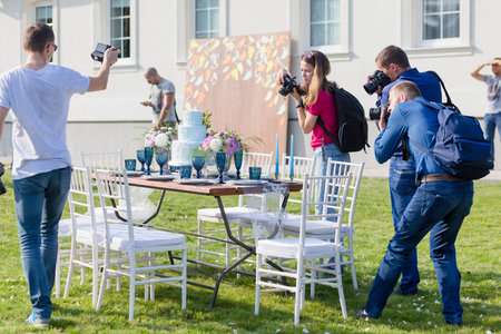 RADZIVILKI, BELARUS - OCT 10: Photographers shoot decorated for wedding elegant dinner table at the wedding workshop at October 10, 2016 in Radzivilki, Belarusのeditorial素材