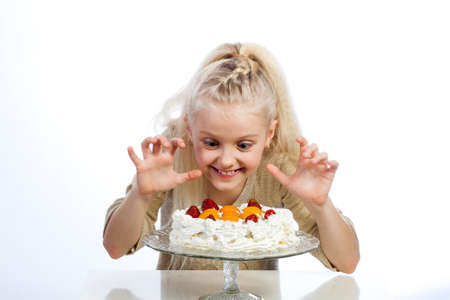 Girl eats a cake on white background.の写真素材