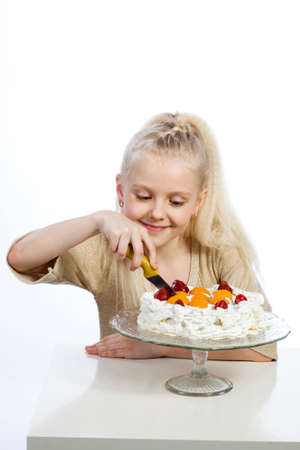 Girl eats a cake on white background.の写真素材