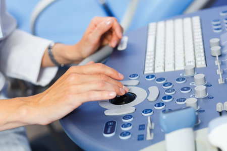 Hands of a doctor who uses the medical ultrasound diagnostic machine