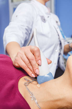 Young Woman Doing Neck Ultrasound Examination At Hospitalの写真素材
