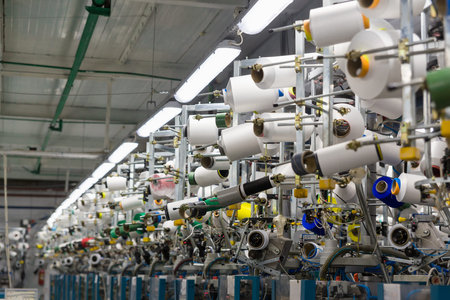 Textile industry with knitting machines in factoryの写真素材