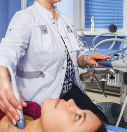 Young Woman Doing Neck Ultrasound Examination At Hospitalの写真素材