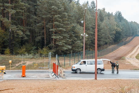 GRODNO, BELARUS - NOV 15: A female border guard checks the documents on Belarusian-Polish border line, November 15, 2013 in Grodno, Belarusのeditorial素材