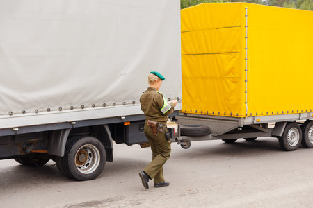 Grodno, Belarus - November 15, 2013: A female border guard checks the documents on Belarusian-Polish...