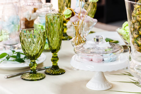 Festive table, decorated with vases, fruits and pastries.  In the decoration of the table used...