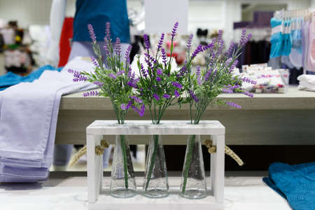 Decorative vases with lavender flowers are used to decorate womens clothing boutiqueの写真素材