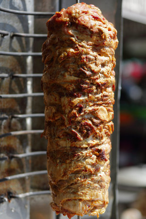 Shawarma meat being cut before making a sandwich