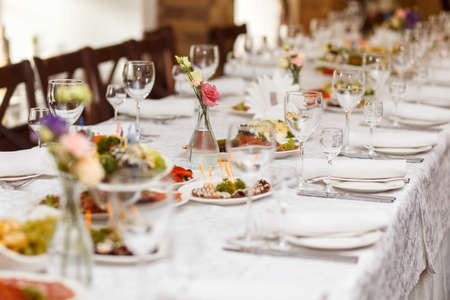Served for a banquet table. Wine glasses with napkins, glasses and salads.の写真素材