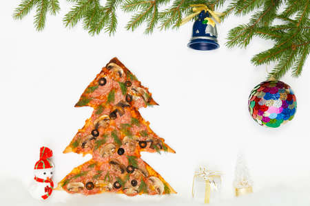 Greeting card with a pizza in the shape of a Christmas tree and giftsの写真素材