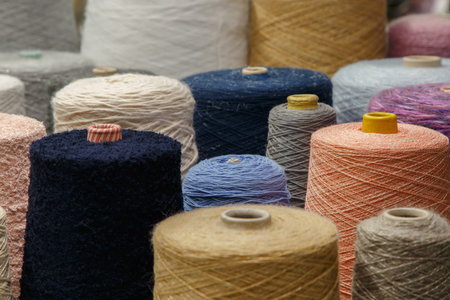 Colorful yarn on spool at the knitting factory.  Yarn on tube, cotton, wool, linen thread.