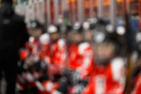 Blurred image of professional player sitting on bench and waiting for substitutionの写真素材