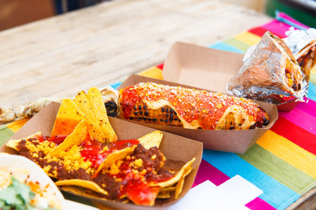 Set of mexican fast food - quesadillas, corn, nachos, gazpacho and other on street food festival