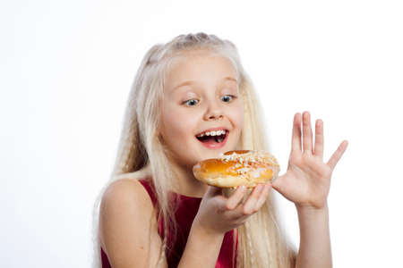Girl looking at croissant on white background.の写真素材