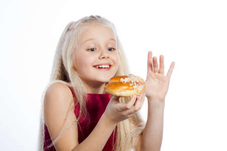 Girl looking at croissant on white background.の写真素材