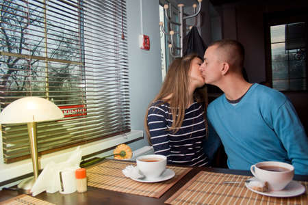 Couple in love drinking tea and having fun in a cafeの写真素材