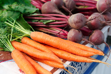 Ripe beet and carrot on the counter of the Belarussian market. Fresh vegetables in the street...