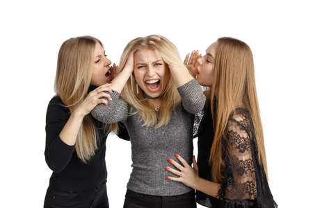 The young girl screams, because she can no longer tolerate lies from all sides. Concept photo. Isolated on a white background.の写真素材
