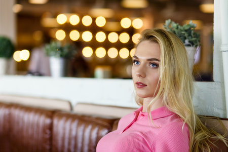 Young pretty woman wearing in pink polo resting in cafe