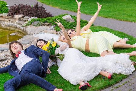 Newly married with bridesmaids having fun on wedding ceremonyの写真素材