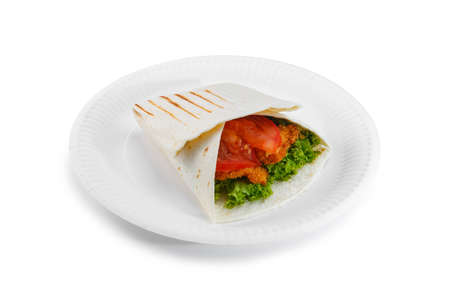 Shawarma sandwich on paper plate isolated on white background. Gyro fresh roll with pita with grilled chicke, lettuce salad, bacon, tomato, sauces, cheese and vegetables.の写真素材