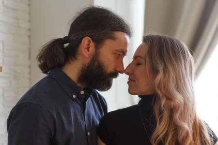 Man embracing pregnant partner in kitchen. Adult family pregnancy concept. Future parents in home outfit embrace standing in the kitchen. Healthy Lifestyle.の写真素材