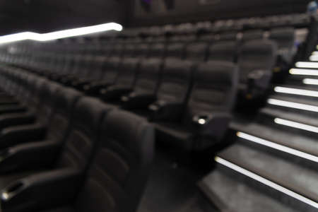 Defocused image of empty black leather seats at movie theater - great entertainment fun background imageの写真素材