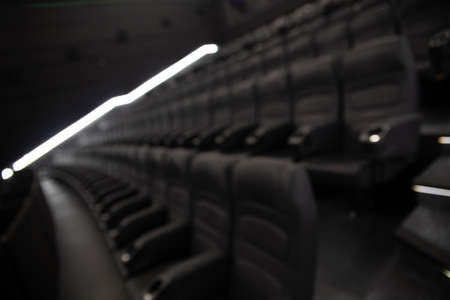 Defocused image of empty black leather seats at movie theater - great entertainment fun background imageの写真素材