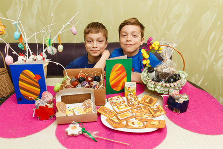 Two boys demonstrate their own handmade Easter decorations. Painted eggs, applique, decorated...