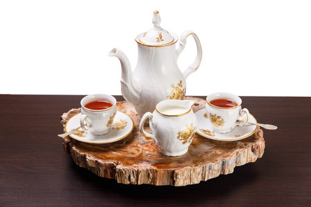 Elegant coffee set on an exclusive tray made from a cut of ancient petrified wood