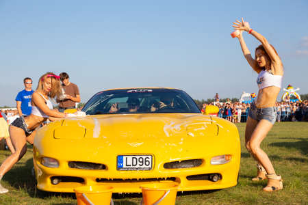 Grodno, Belarus - July 23, 2016: Semi-naked girls erotically wash a sports car at the international automobile festival Sunday 2016のeditorial素材