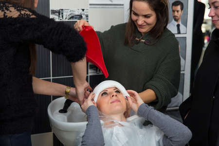 Grodno, Belarus - October 20, 2016: Participants of the seminar dye the hair of a model on advertising workshop of Keune brand in the beauty salon Kolibri.のeditorial素材