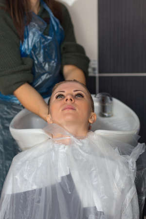 Grodno, Belarus - October 20, 2016: Participants of the seminar dye the hair of a model on advertising workshop of Keune brand in the beauty salon Kolibri.のeditorial素材