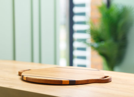 Empty round wooden tray on table against blurred background for product display montage.の写真素材