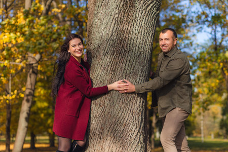 Lovely couple having fun together in nature. Boyfriend hugging his girlfriend. Holidays, love, travel, tourism, relationship and dating concept.の写真素材