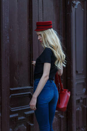 Close up image of fashionable woman in city. Wearing amazing trendy black shirt and red hat.の写真素材