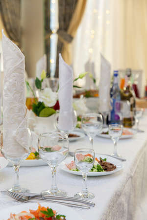 Beautiful table served with glassware and cultery, prepared for festive event. Special occasion celebrted in luxury restaurant or cafe. Table setting concept. Wedding table.の写真素材