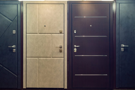 Entrance doors for sale in a specialized store. Buyers prefer metal doors, stylized as wooden.