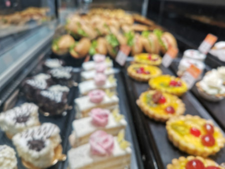 Blured view of the cake shelves in the store, a lot of cakes in the store, the product line with cakes, product shelves in the marketの写真素材