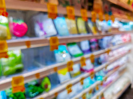 Blur abstract background of shopping in super market ,products on shelves ,Supermarket with bokeh,customer defocus ,vintage colorの写真素材