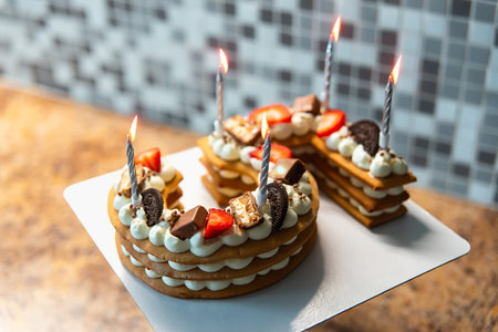 Cake in the form of number five, with biscuit cakes and cheese cream and decorated with cookies and...