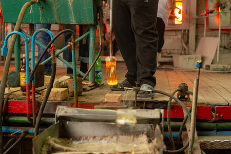 Beryozauka, Belarus - March 07, 2022: A team of glass blowers is working on the manufacture of glass...