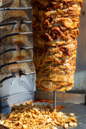 Close up shot of stacked meat roasting to be used in preparation of traditional Greek dish gyros or...