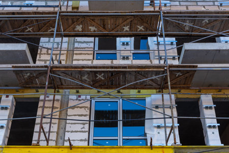 Insulation of the exterior walls of a building under construction. The walls of the building under...