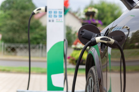 Power supply connect to electric vehicle for charge to the battery. Charging technology industry transport which are the futuristic of the Automobile. EV fuel Plug in hybrid car.の写真素材