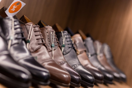Leather shoes were lined up on the store shelves. Men elegant shoes in a man clothing boutique. Some models are sold at a discount.の写真素材