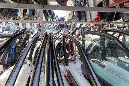 Disassembled cars on a car dump are on sale for spare parts. A stack of doors and bumpers. Trade in...