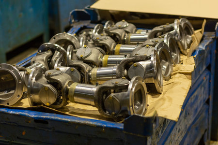 Cardan shafts and gimbal transmissions laying in box during production process. Production of...